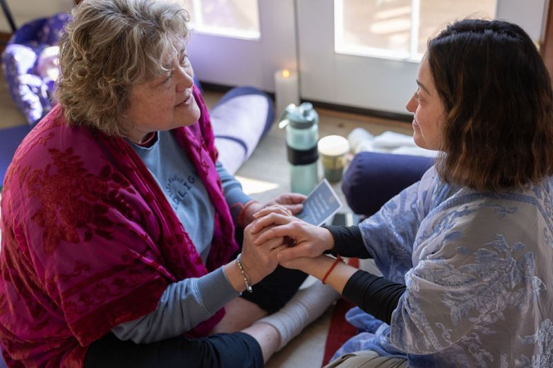 two women holding hands supporting each other